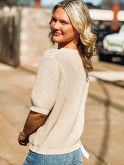 Knitted taupe half sleeve sweater with. a full button front and a crew neckline