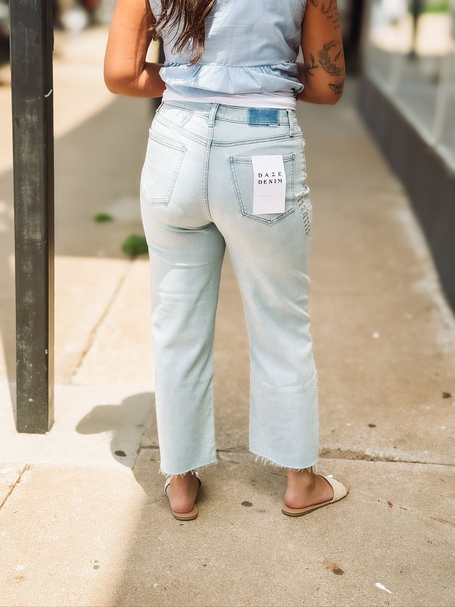 Light wash raw hem wide leg cropped jean by Daze.