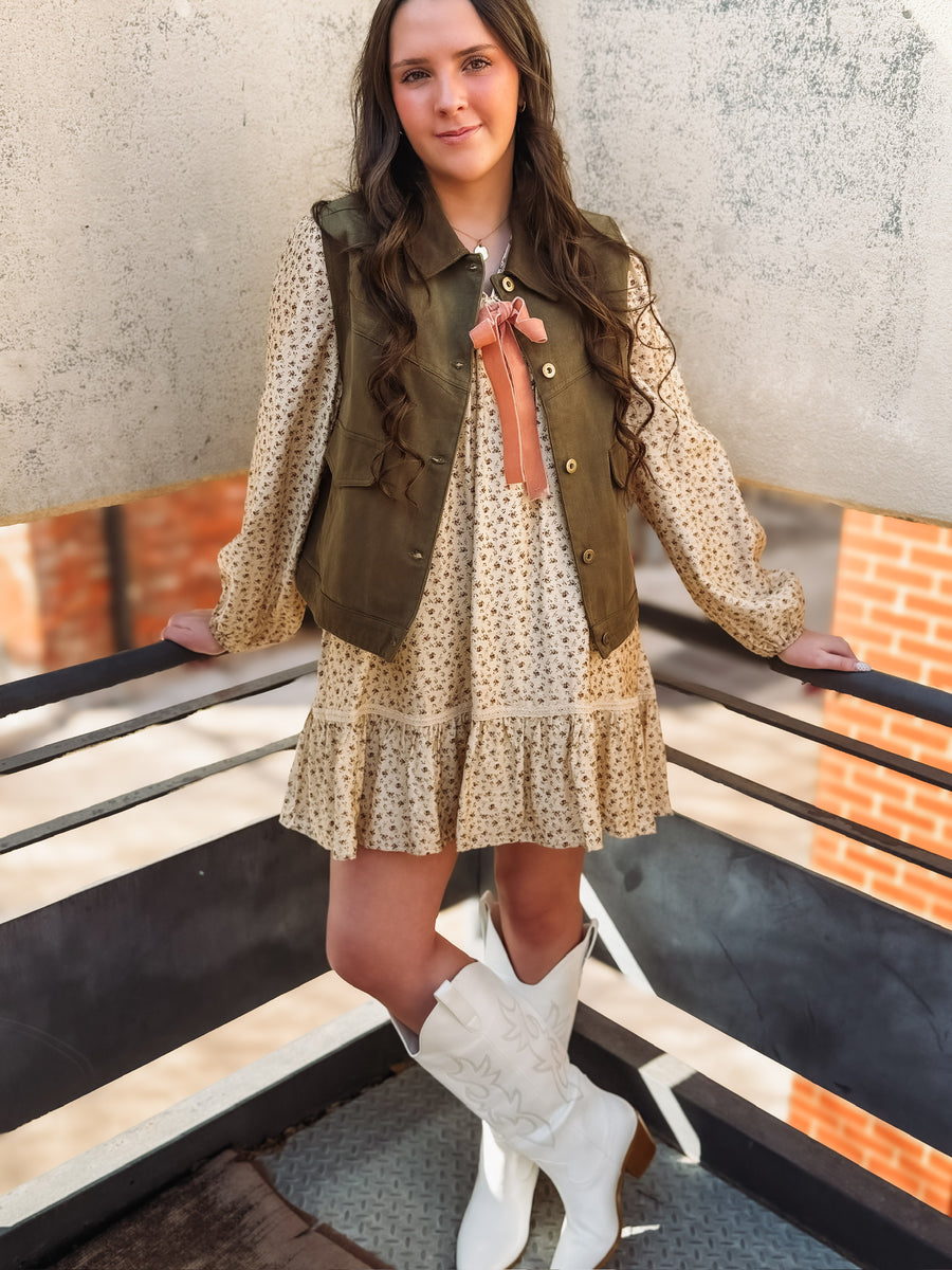Long cream bubble sleeve mini dress with dainty floral detail and a laced bow detail.