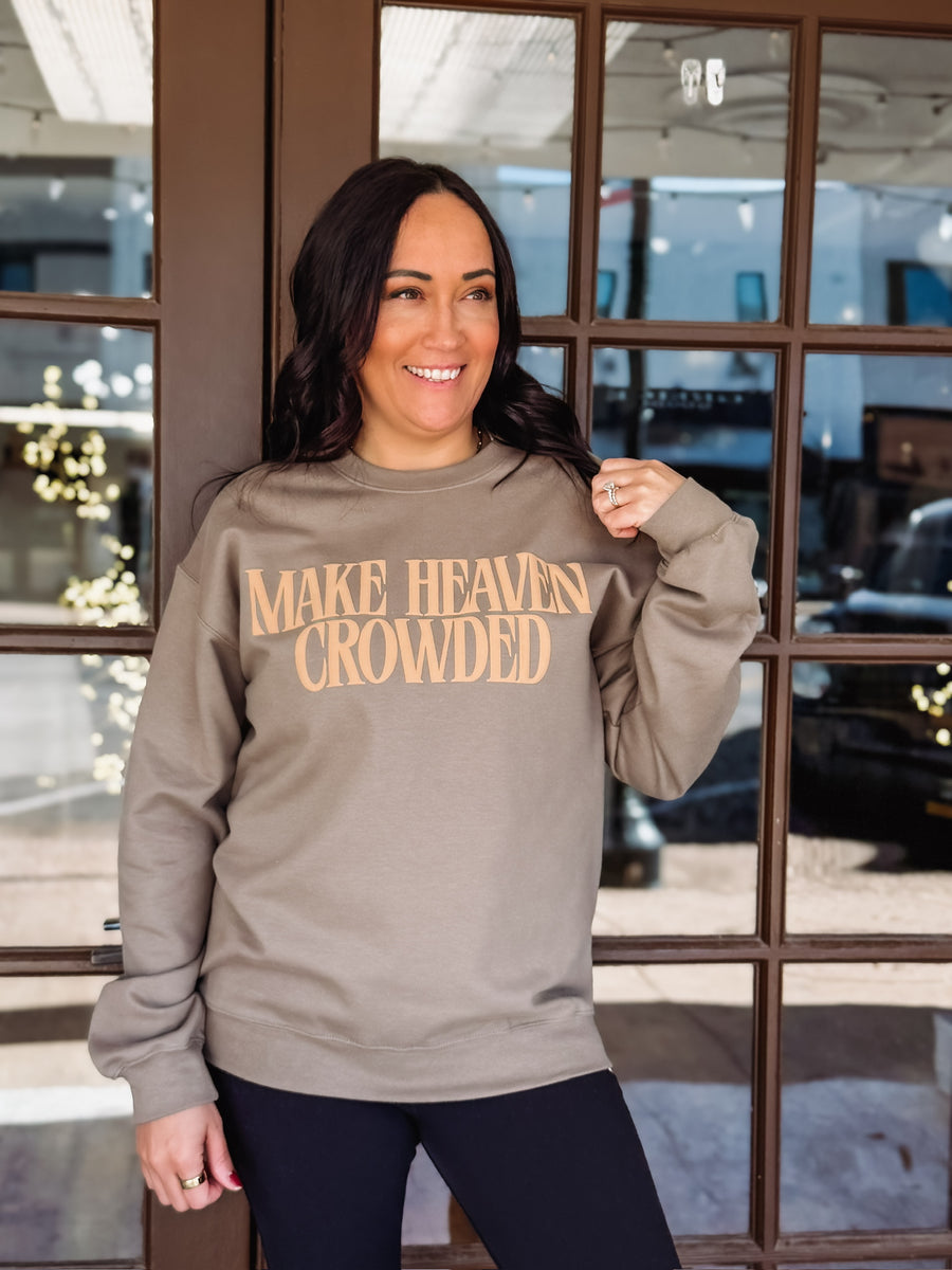 Make Heaven Crowded printed in a golden brown puff lettering on a brown Gildan sweatshirt 