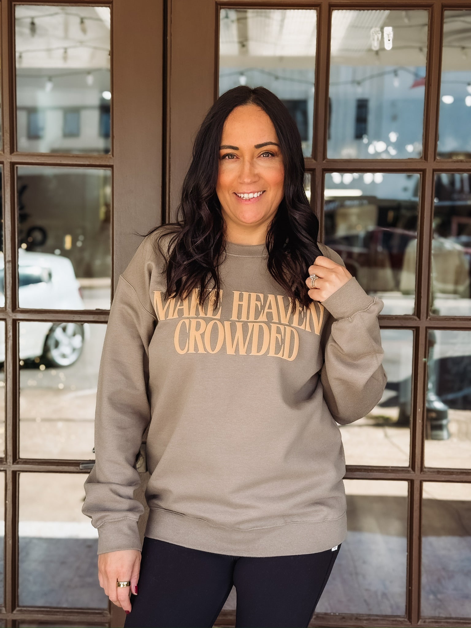 Make Heaven Crowded printed in a golden brown puff lettering on a brown Gildan sweatshirt 