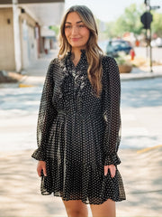 Black long sheer sleeved mini dress with a ruffle button up design.