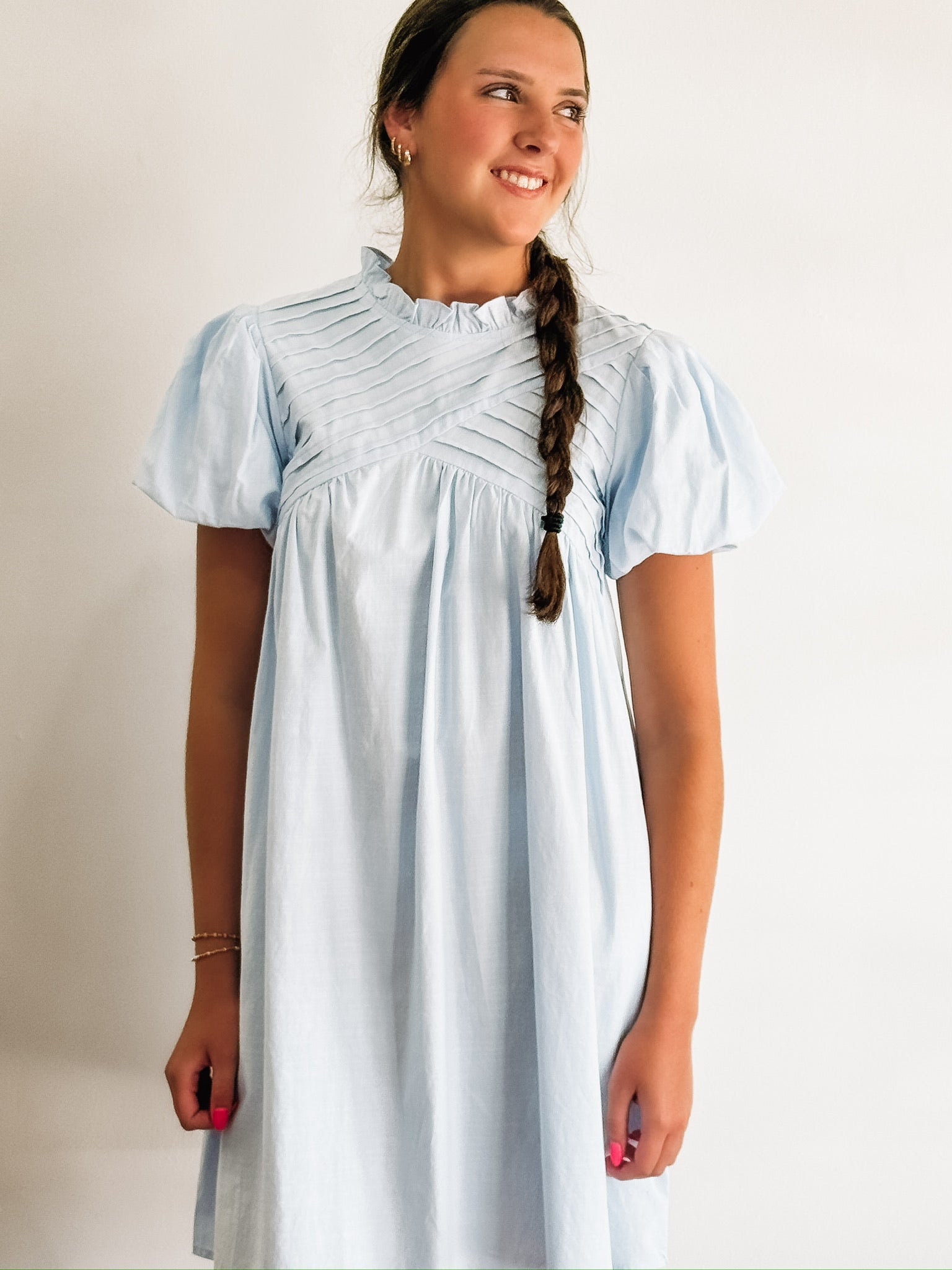 Pintuck short sleeve bubble sleeve mock neck dress.