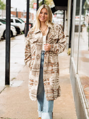Muted neutral and rust long duster jacket with aztec print and a full button up front.