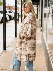 Muted neutral and rust long duster jacket with aztec print and a full button up front.