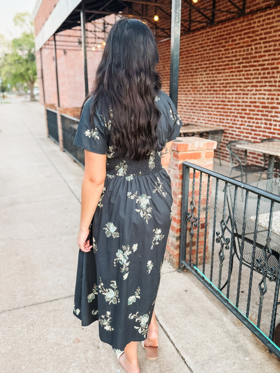 Short sleeve navy floral midi dress with v neck and zip front closure and smocked waist.