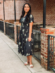 Short sleeve navy floral midi dress with v neck and zip front closure and smocked waist.