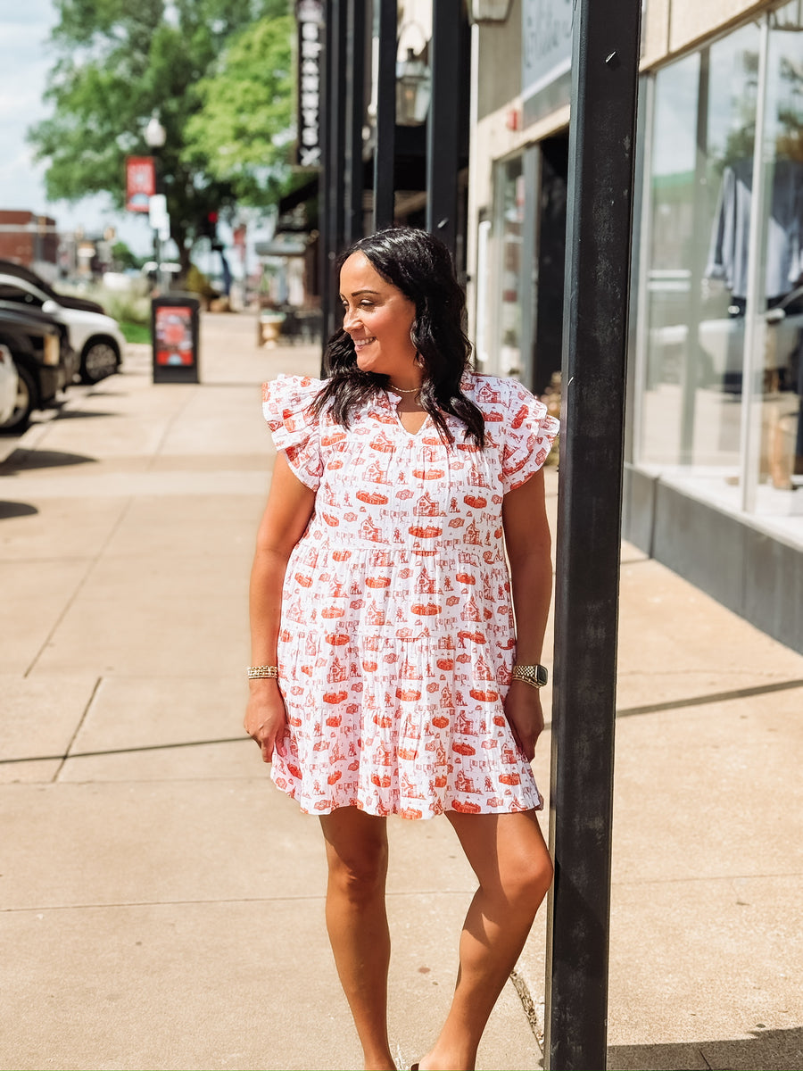 Orange and white OSU-themed toile dress with flutter sleeves, featuring a fitted waist and flowy silhouette.