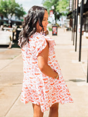 Orange and white OSU-themed toile dress with flutter sleeves, featuring a fitted waist and flowy silhouette.