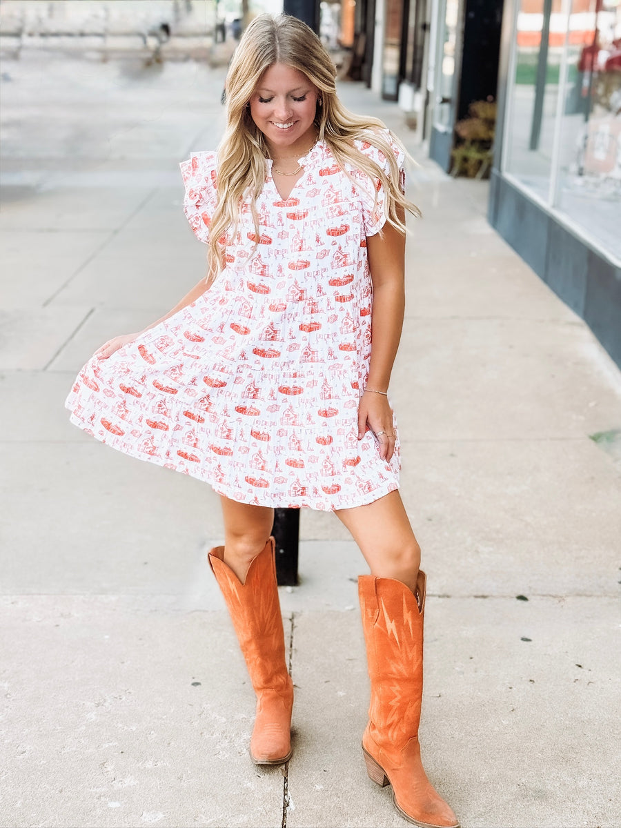 Orange and white OSU-themed toile dress with flutter sleeves, featuring a fitted waist and flowy silhouette.