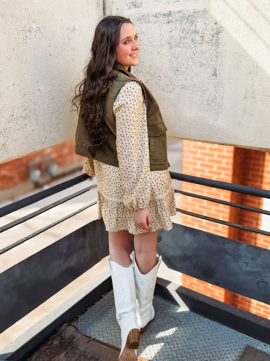 Olive utility vest with suede detailing and snap buttons.