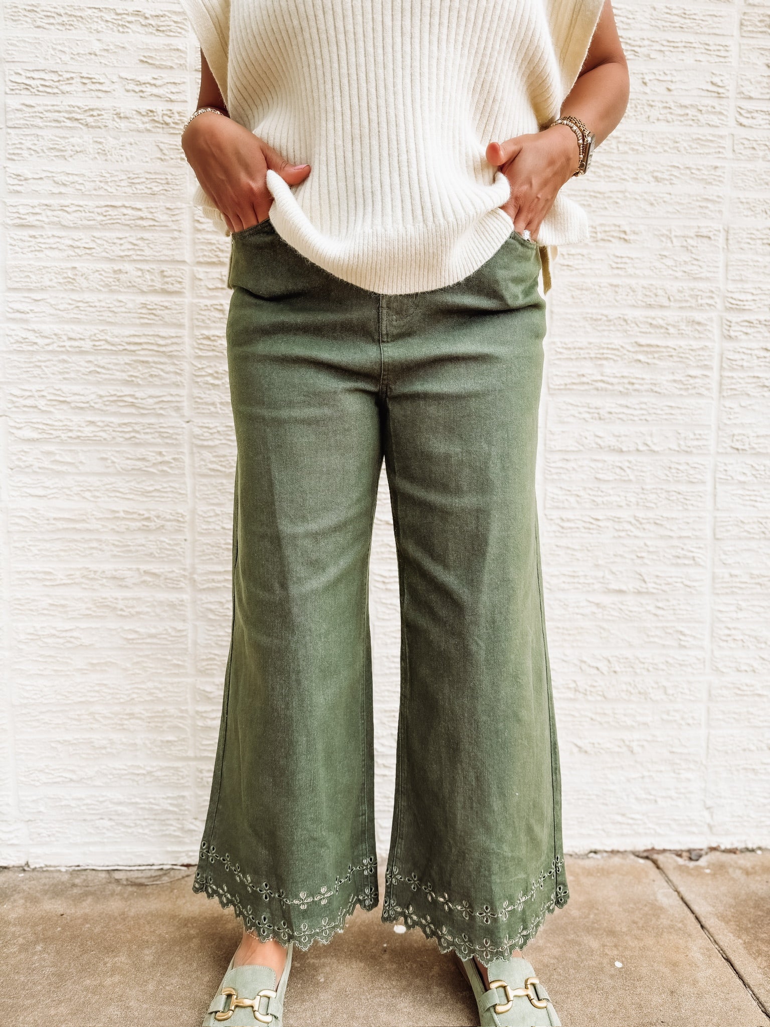 Olive green soft denim cropped jeans with eyelet detailing at the hem.