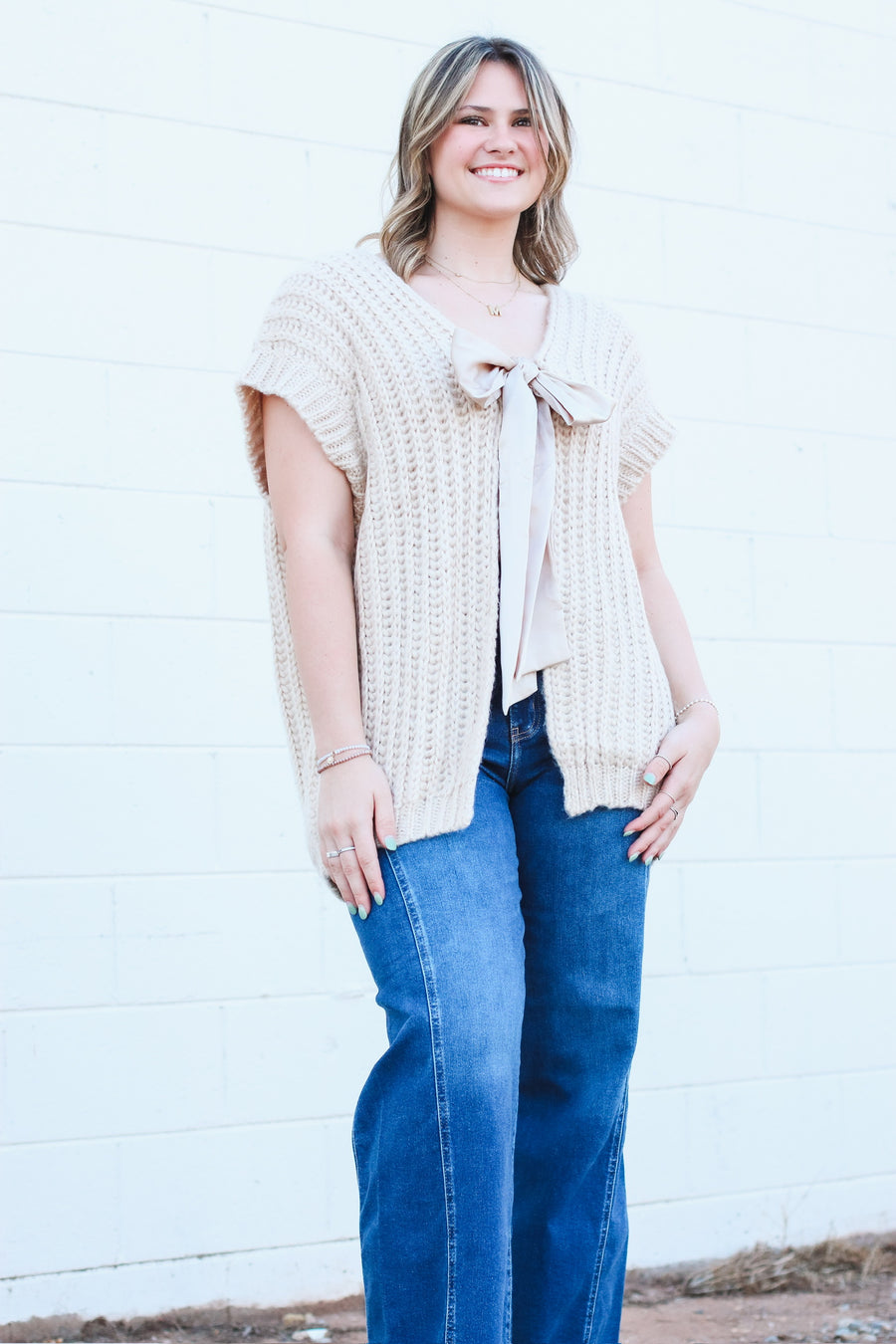 Oversized taupe short drop sleeve cardigan with a satin bow front closure.