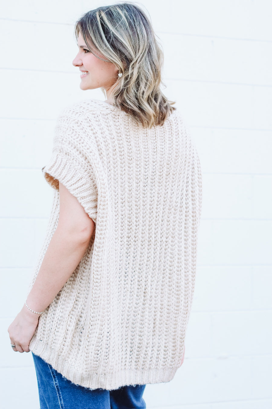 Oversized taupe short drop sleeve cardigan with a satin bow front closure.