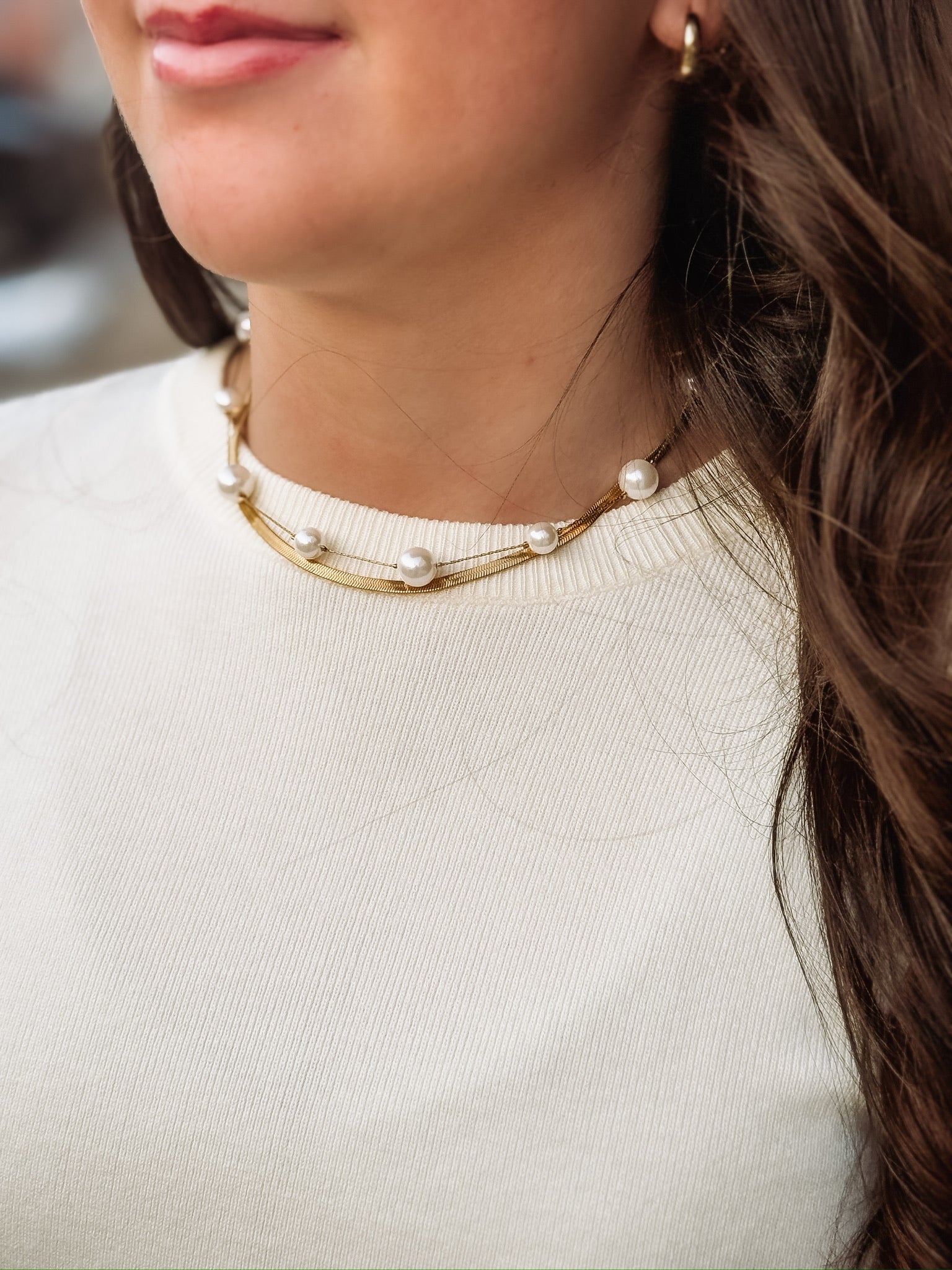 duo necklace with 2 separate pieces, a gold chain and a spaced pearl necklace.