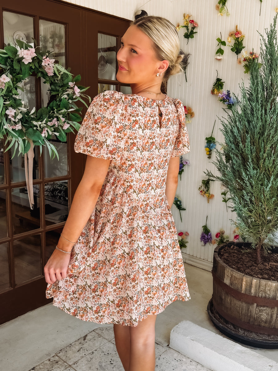 Pink and peach hued floral dress with ruffle detail