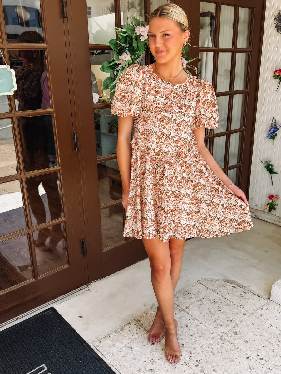 Pink and peach hued floral dress with ruffle detail