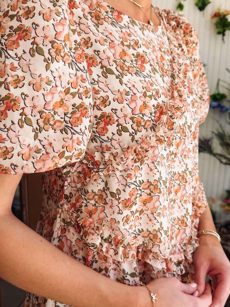 Pink and peach hued floral dress with ruffle detail