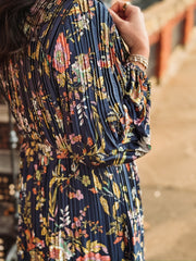 Pleated long sleeve maxi dress on a navy base with multi color floral detail.