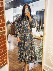 Pleated long sleeve maxi dress on a navy base with multi color floral detail.