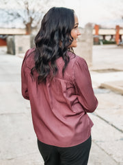 Plum pleated satin long sleeve blouse with back detailing.