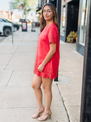 Tomato red short sleeve mini dress with eyelet detailing on the hem and sleeves. 