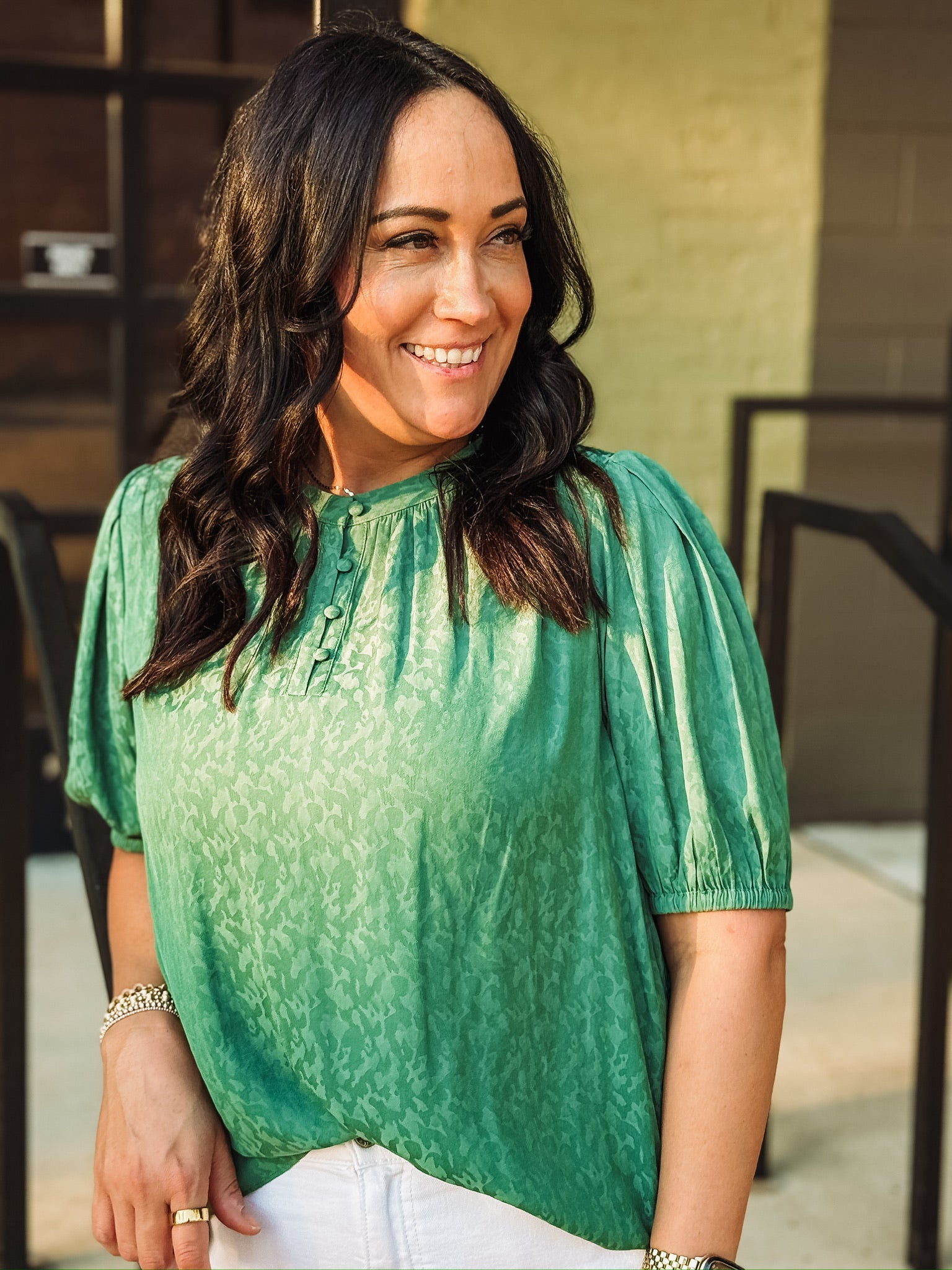 Green on green printed blouse with elastic short sleeves and a quarter button up crew neckline.