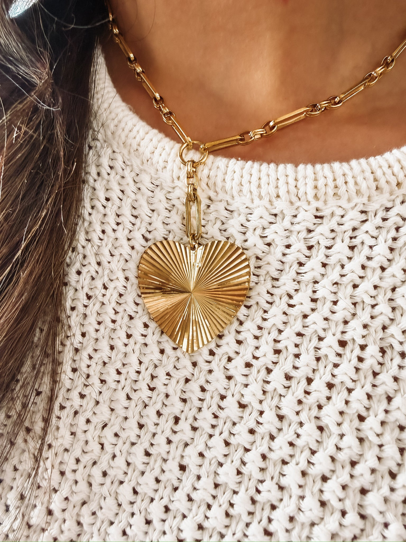 Short chain link necklace with a drop down pave heart pendant.