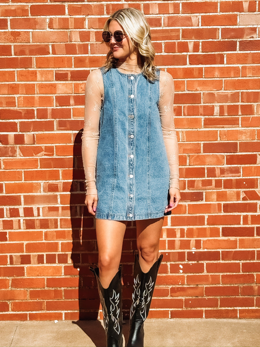 Sleeveless light wash button up denim dress.