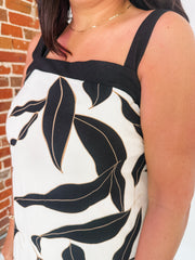 Black trim dress with cream base and large black and gold leaf design.