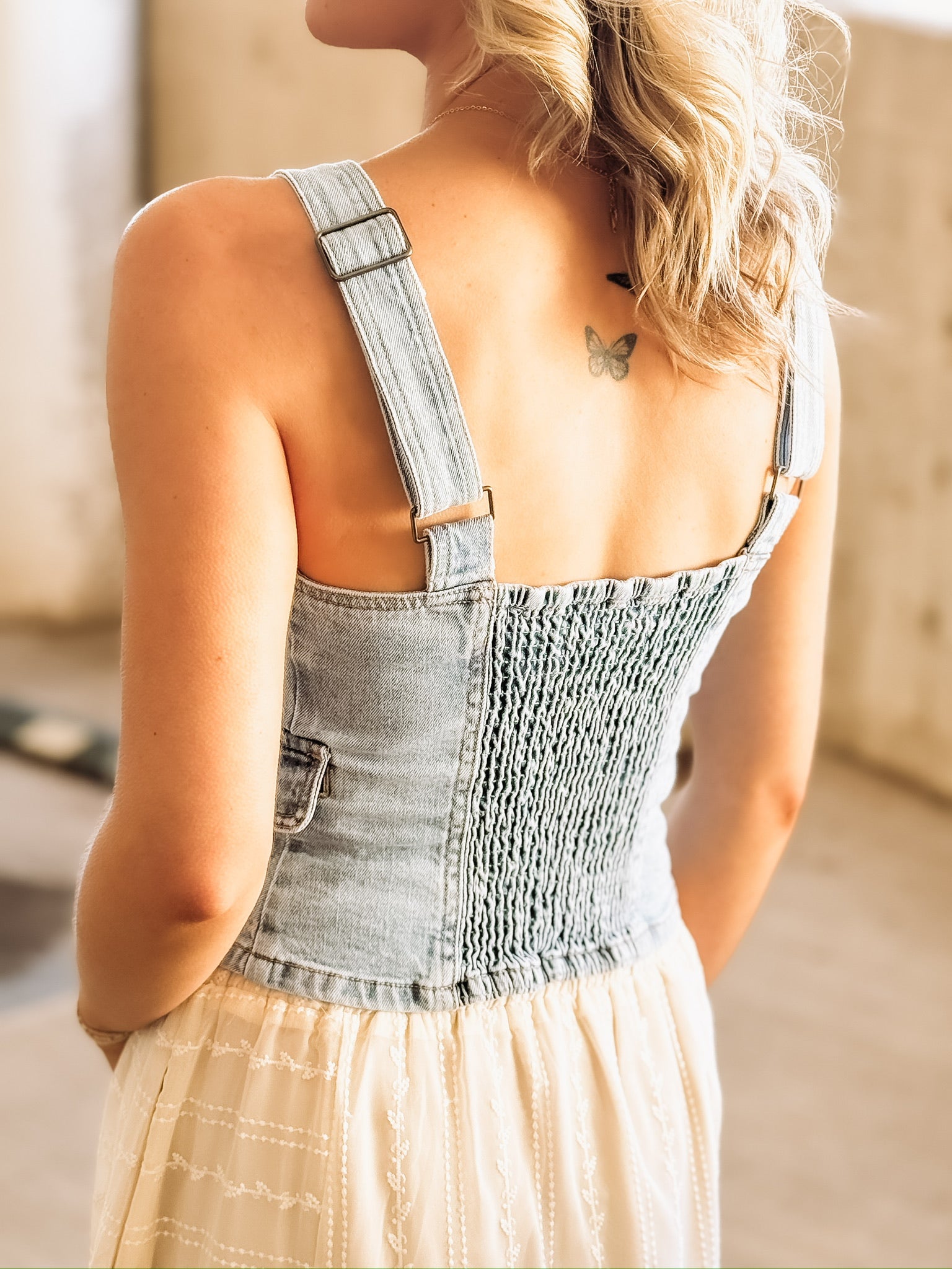 Fitted stretchy light wash denim vest top.