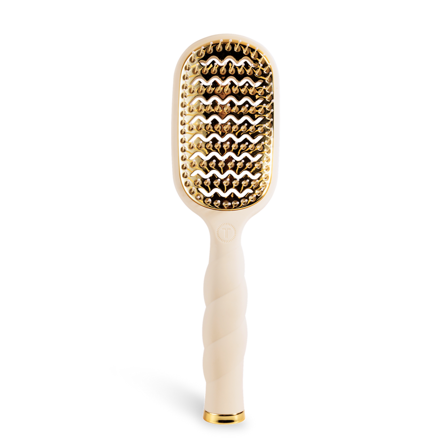 Hairbrush with gold bristle head and tan handle 