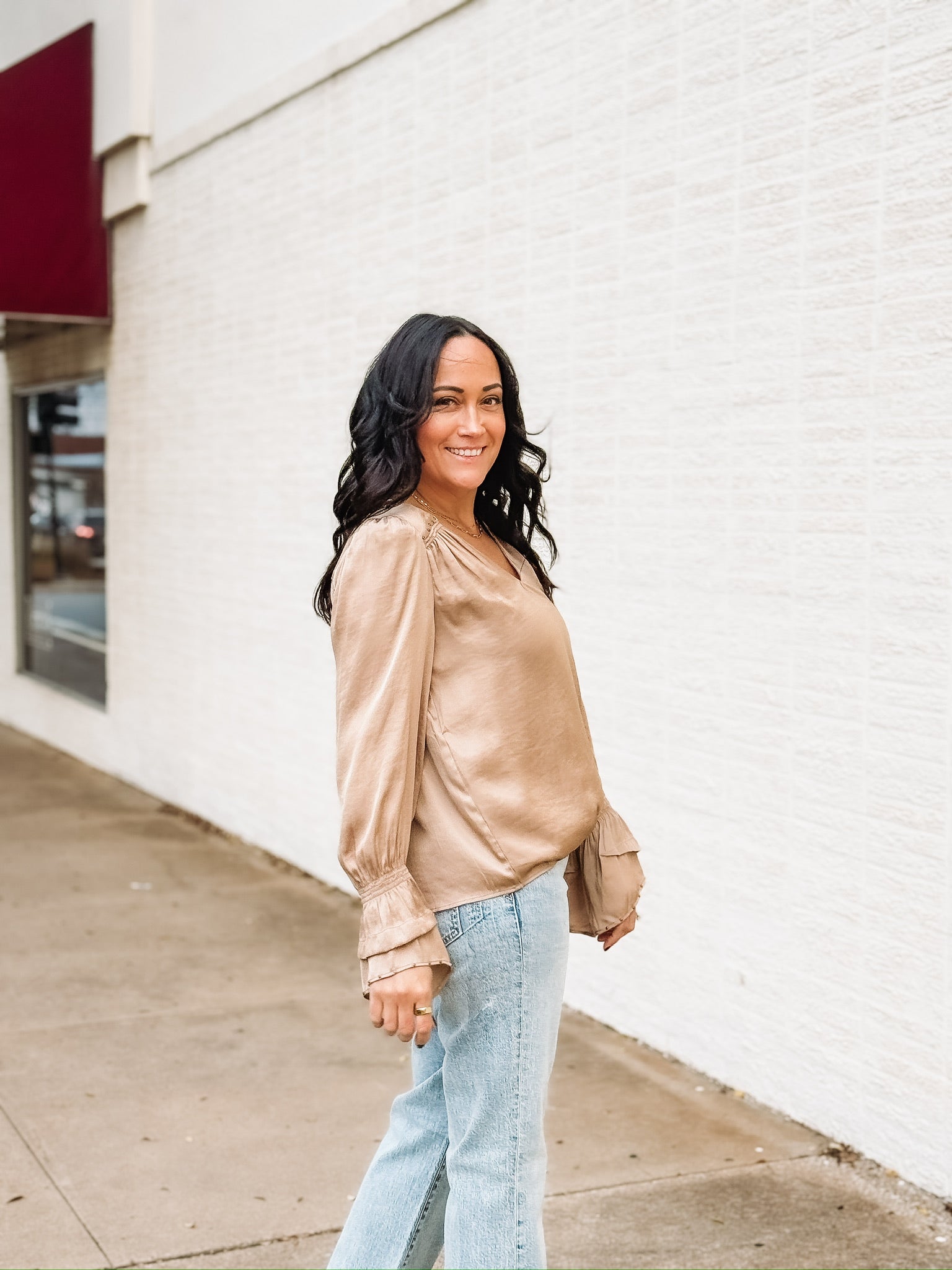 Tan satin long sleeve blouse with bell sleeves and studded detailing.