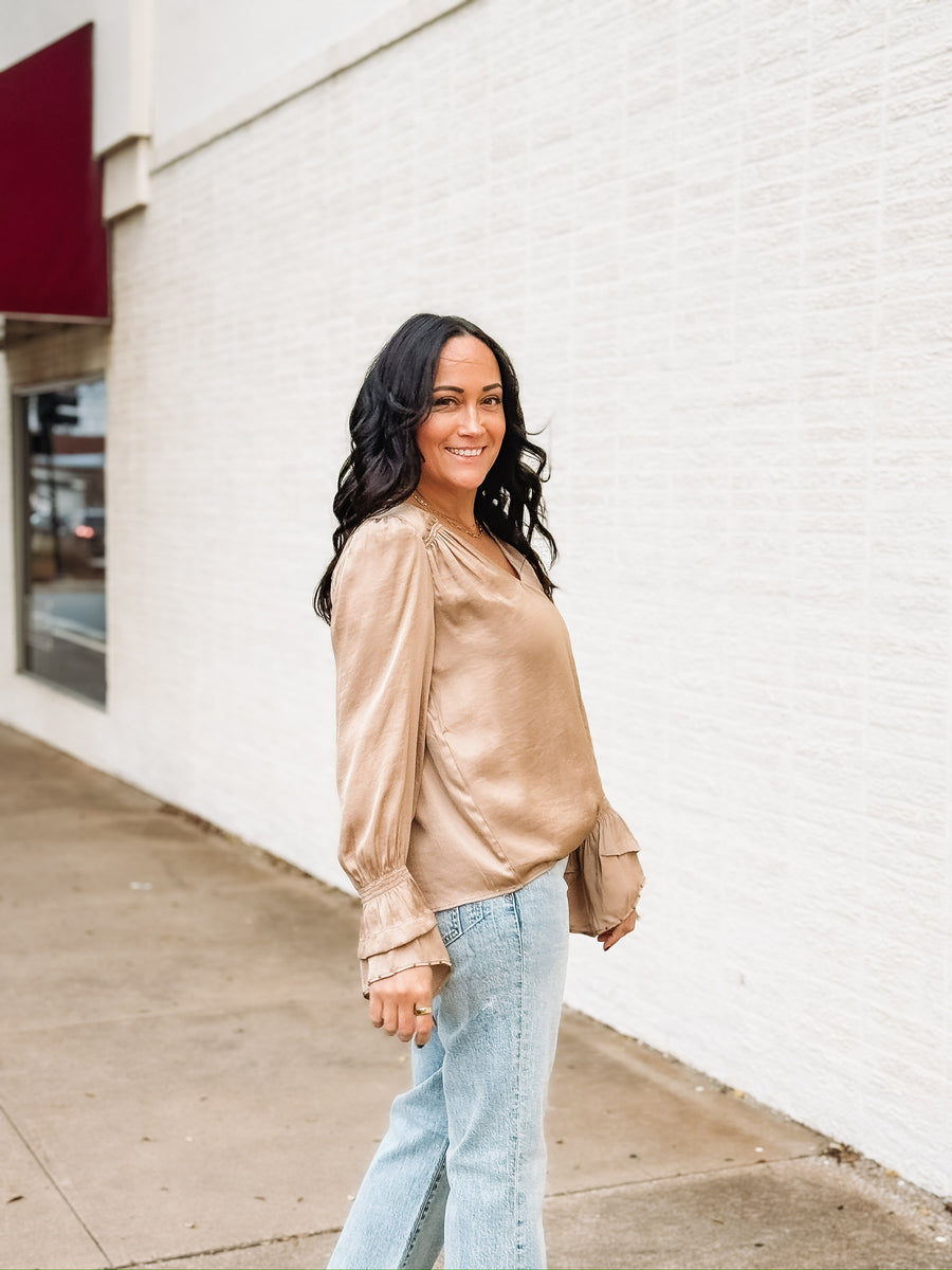 Tan satin long sleeve blouse with bell sleeves and studded detailing.