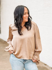 Tan satin long sleeve blouse with bell sleeves and studded detailing.