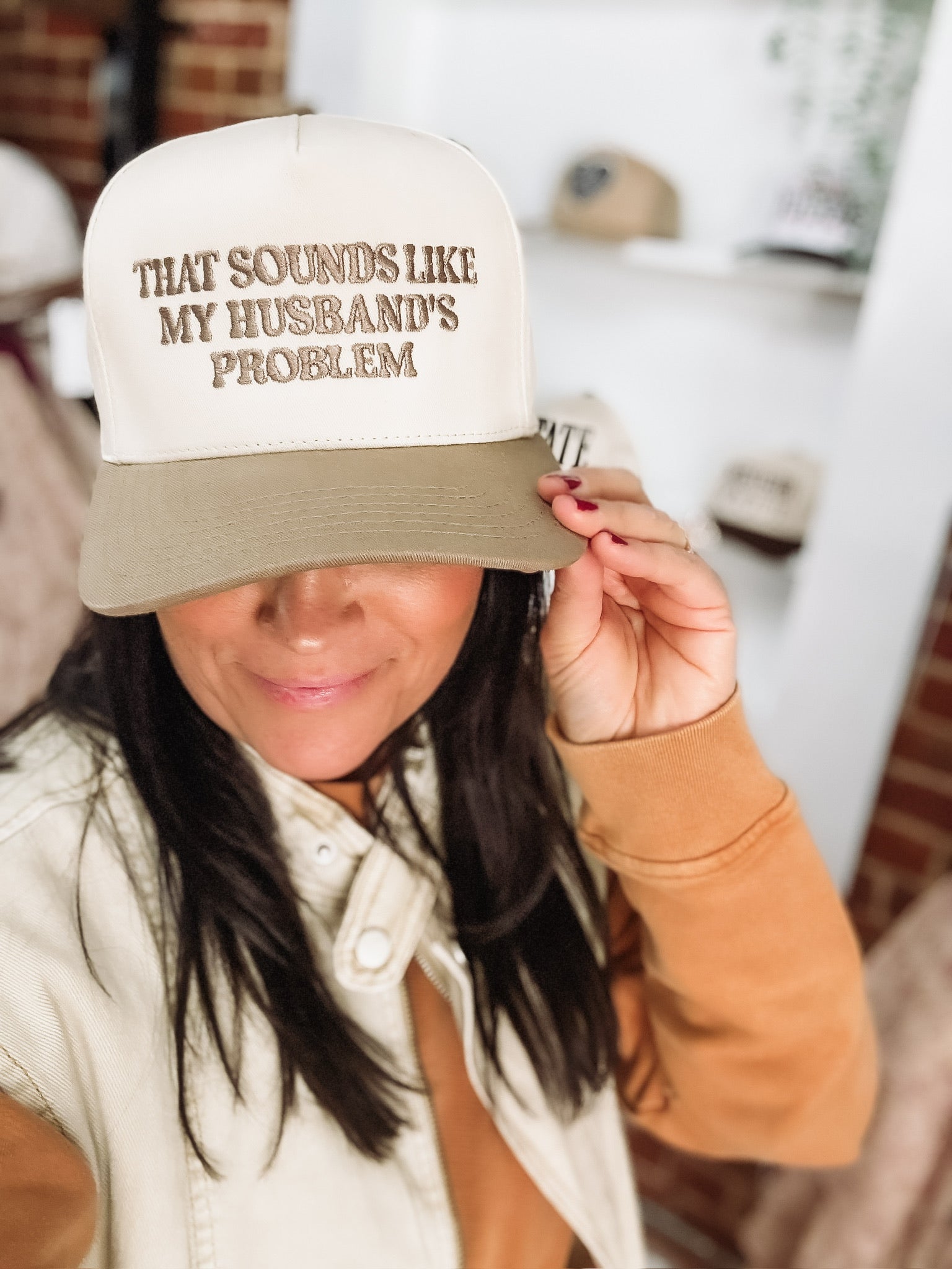 ‘That Sounds Like My Husband’s Problem’ embroidered in beige on a two tone canvas and beige hat.