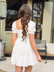 White tiered ruffle short smocked sleeve and back mini dress.
