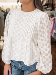 White long sleeve blouse with tonal checkered texture and shiver balloon sleeves.
