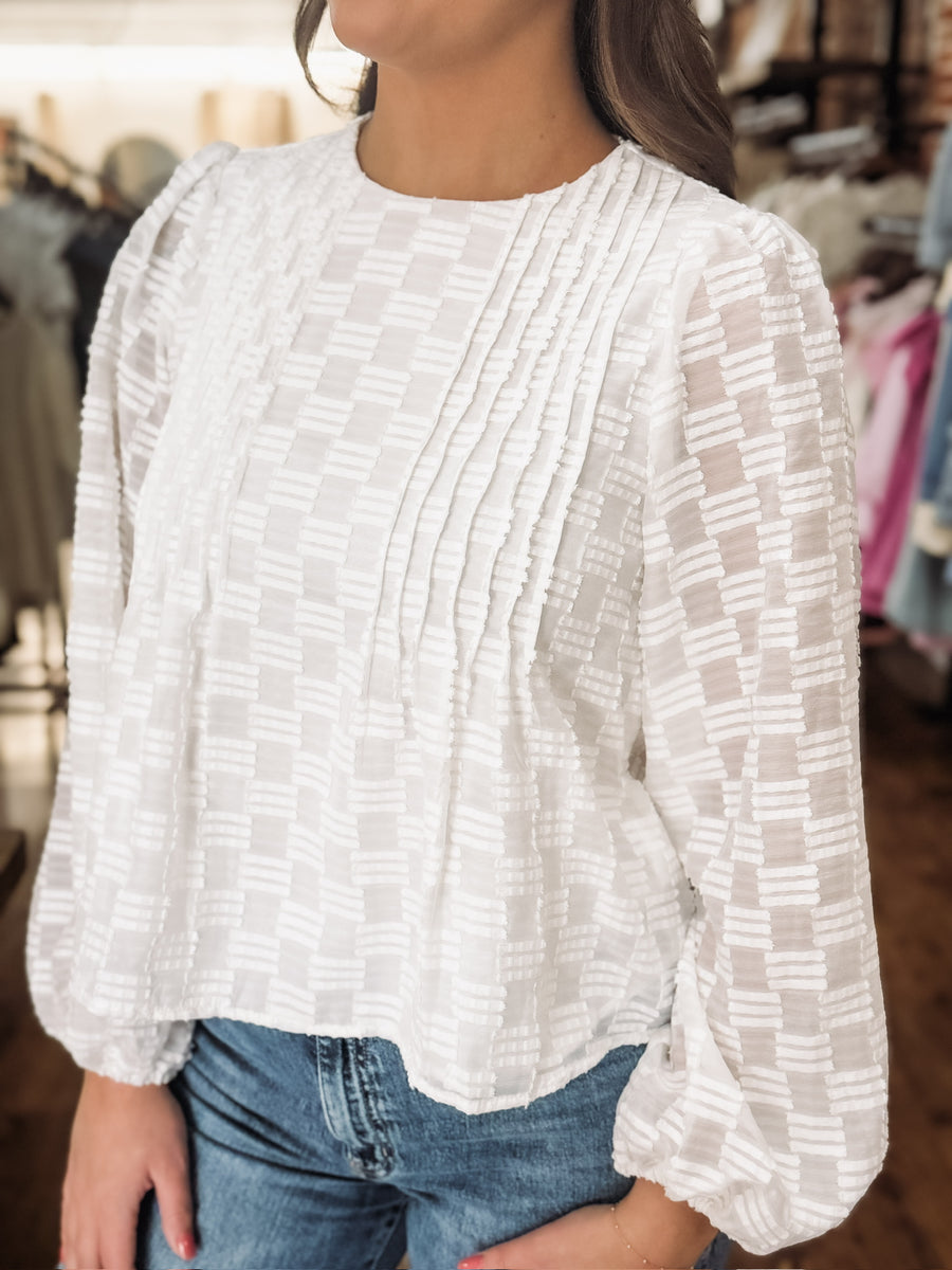 White long sleeve blouse with tonal checkered texture and shiver balloon sleeves.