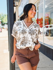 Brown V-neck floral blouse in a relaxed fit with short sleeves