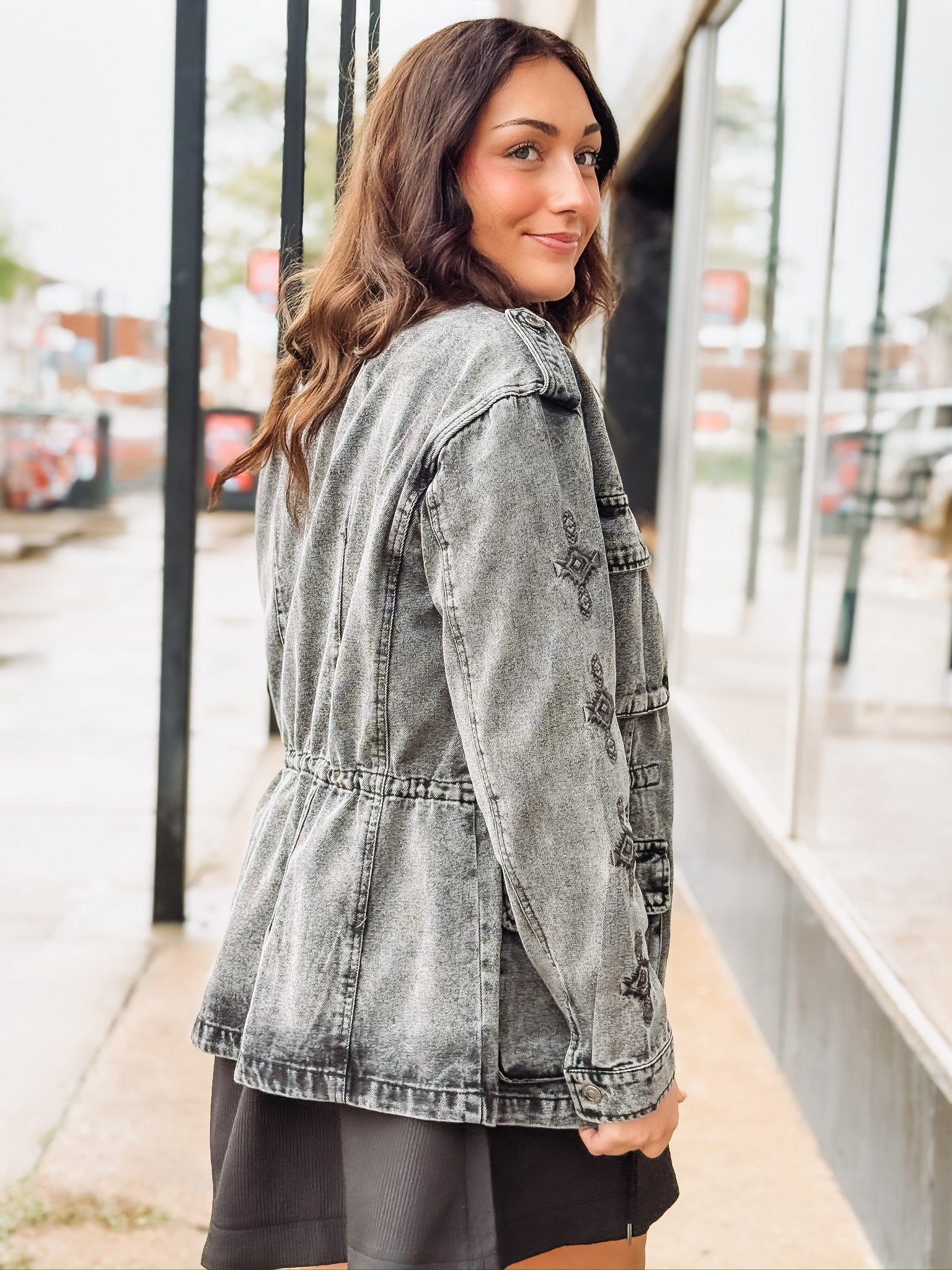 Black washed denim  anorak jacket with aztec print, a zipper and snap button front.