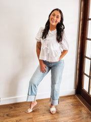 white peplum top with cut out eyelet details and bow tie front
