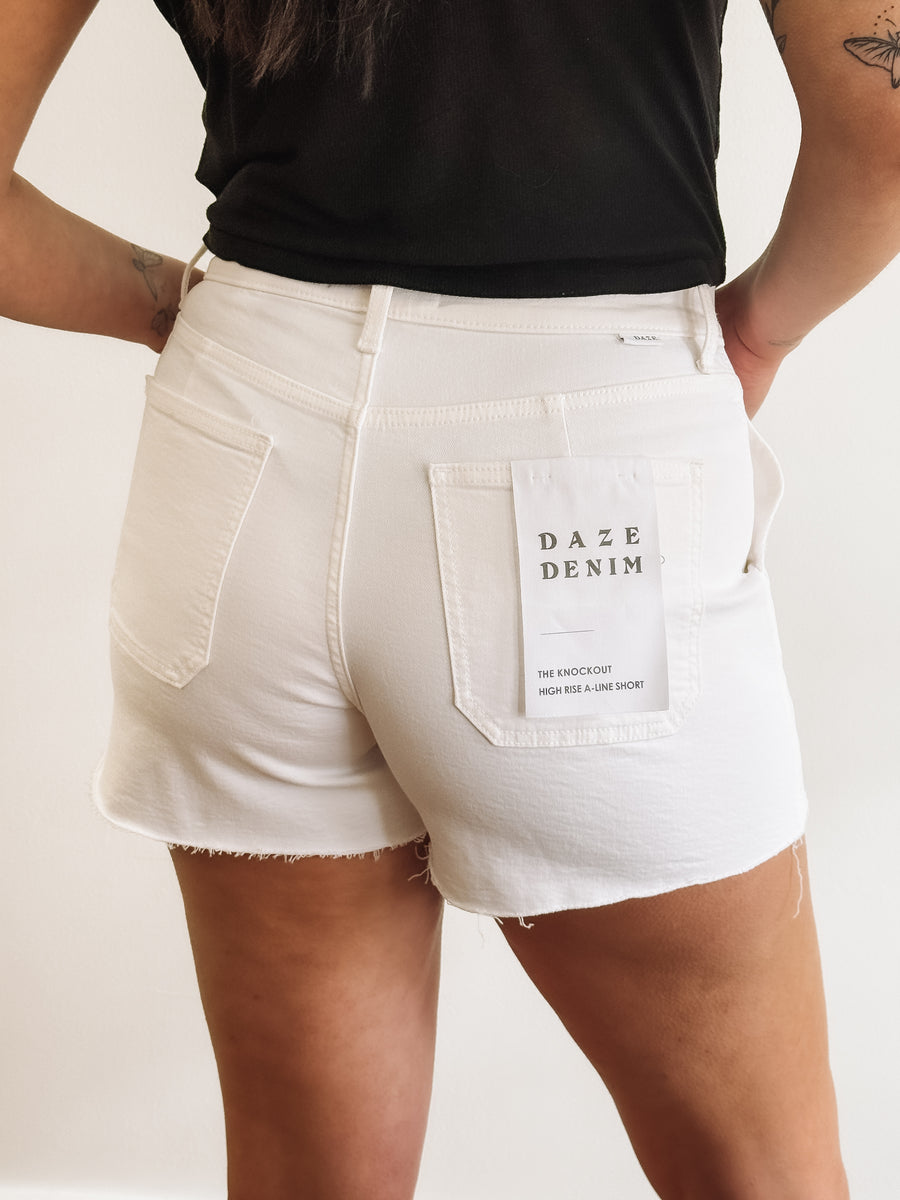 White cargo denim shorts with raw hem by Daze.