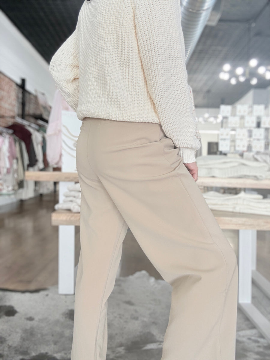 Womens pleated cropped trouser pants with front pockets and faux dress pant pockets on the back.