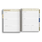 Open daily planner with floral design on a white background