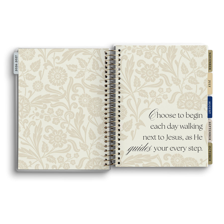 Open notebook with floral design and inspirational quote on a white background