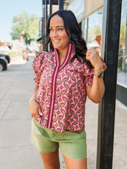 Blouse with a band collar with a wine, pink, and olive colored geometric print