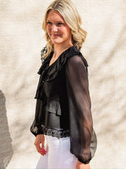 Black long-sleeve blouse featuring a wide ruffled collar with lace trim, sheer balloon sleeves, a ruffled bodice detail, and an intricate lace hemline