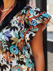 Flutter cap sleeve floral top with orange contrast seaming.