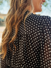 Black long sheer sleeved mini dress with a ruffle button up design.